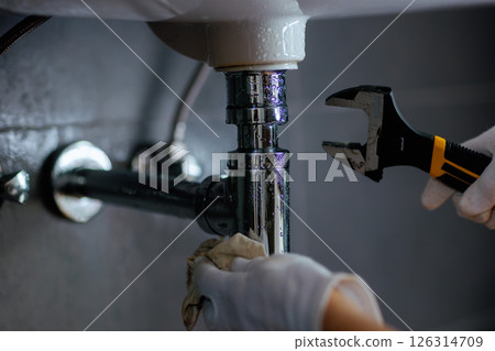 Plumbing Maintenance Under Sink 126314709