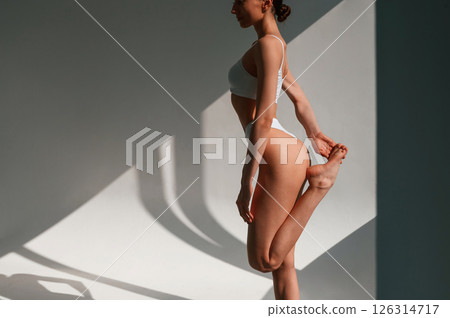 Slim body shape. Young caucasian woman is indoors in the studio Slim body shape. Young caucasian woman is indoors in the studio 126314717