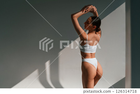 Slim body shape. Young caucasian woman is indoors in the studio Slim body shape. Young caucasian woman is indoors in the studio 126314718