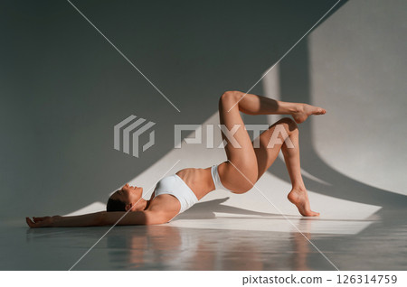 Slim body type. Young caucasian woman with is indoors in the studio 126314759