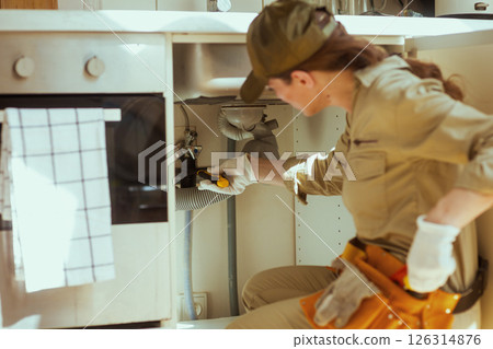 Plumber at Work Under Kitchen Sink 126314876