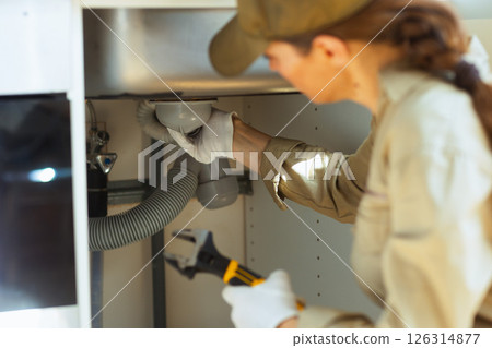 Plumber Repairing Sink Drain 126314877