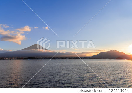 Sunset rays illuminate the horizon, casting a warm glow on clouds and Mount Fuji Sunset rays illuminate the horizon, casting a warm glow on clouds and Mount Fuji 126315034