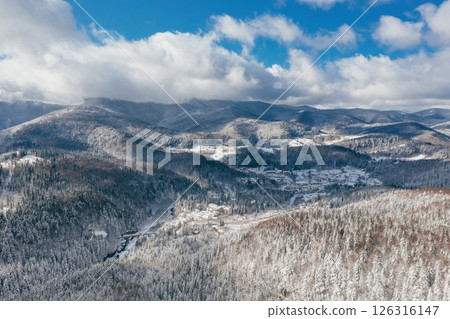 Little town in the Carpathian mountains at winter time. Majestic aerial landscape 126316147