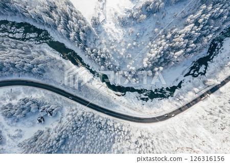 Top aerial view of road and river in the Carpathian mountains. Majestic background Top aerial view of road and river in the Carpathian mountains. Majestic background 126316156
