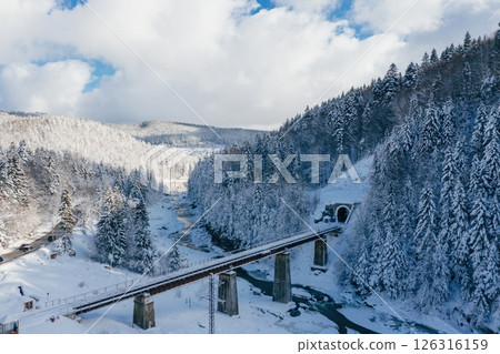 Aerial view of Carpathian mountains. Bridge, river and road with cars. Majestic landscape 126316159