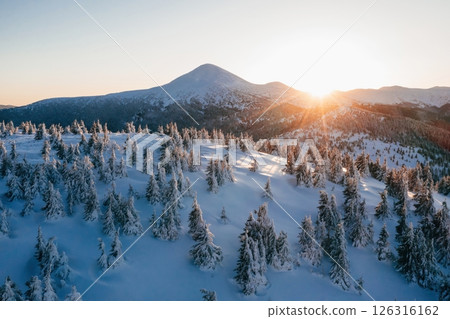 Background with amazing sunset. Winter aerial landscape of majestic Carpathian mountains 126316162