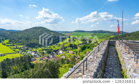 Visitors enjoy a panoramic view from the Donjon Tower of Rabi Castle in Czechia. The lush green landscape stretches across the horizon, showcasing rolling hills and quaint villages below. Visitors enjoy a panoramic view from the Donjon Tower of Rabi Castle in Czechia. The lush green landscape stretches across the horizon, showcasing rolling hills and quaint villages below. 126316811