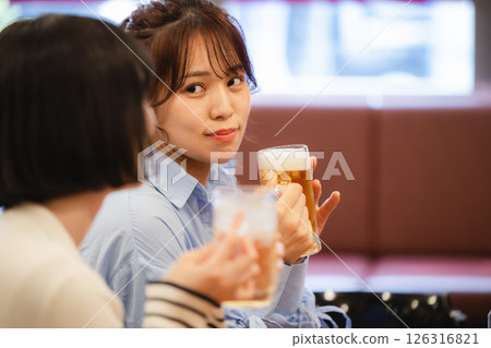 Woman drinking beer Woman drinking beer 126316821