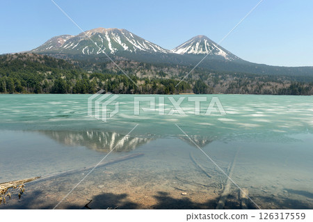 Snow melting lake Snow melting lake 126317559