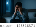 A man in bed at night struggling to sleep 126318371