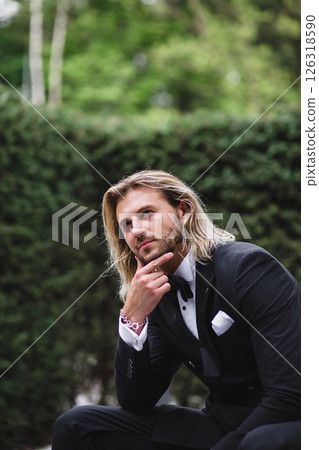 Portrait of handsome young bridegroom with elegant stylish haircut on the territory of country hotel Portrait of handsome young bridegroom with elegant stylish haircut on the territory of country hotel 126318590