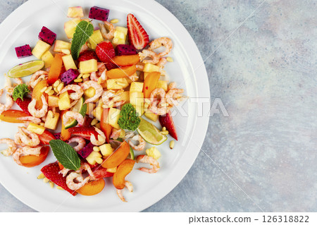 A vibrant shrimp salad featuring tropical fruits. A vibrant shrimp salad featuring tropical fruits. 126318822