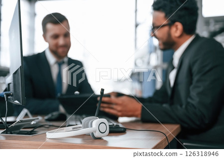 Using modern technology, graphic tablet, pc. Two businessmen are working together in the car showroom 126318946