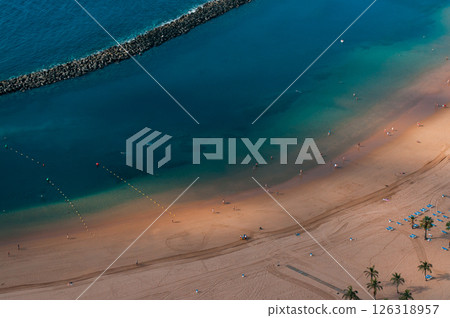 Close-up view of a tranquil sandy beach with turquoise water in Tenerife Close-up view of a tranquil sandy beach with turquoise water in Tenerife 126318957