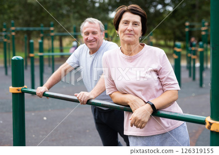 Elderly man and woman posing in open-air sports bars complex 126319155