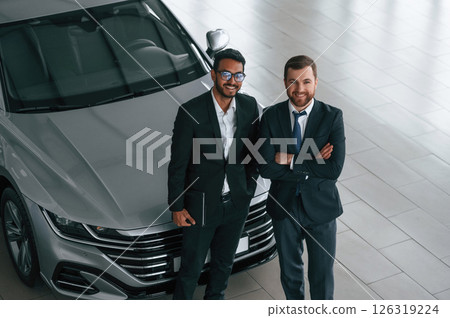 View from the top. Two businessmen are working together in the car showroom 126319224