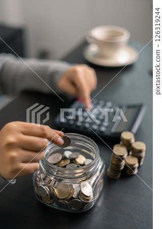 Finance bank tax expense accounting budget money businessman hand use calculator Financial calculate accountant close up calculator with graph chart write office desk Business expense analysis saving 126319244