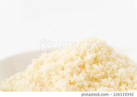 Close-up of grated cheese on a plate Close-up of grated cheese on a plate 126319342