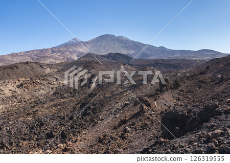 Winter view on colorful volcano Pico del Teide with snow spots from hiking trail Samara. Mountains and lava fields against blue sky. El Teide National Park, Tenerife, Canary Islands, Spain 126319555