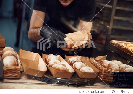Man is taking food in the workspace. Conception of sweet desserts 126319662