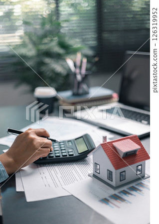 Finance bank tax expense accounting budget money businessman home for Business expense analysis saving use Financial calculate accountant close up calculator with graph chart hand write office desk 126319952