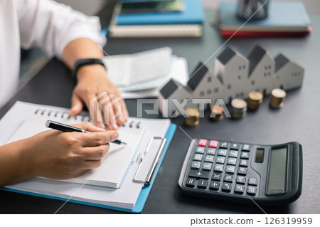 Finance bank tax expense accounting budget money businessman home for Business expense analysis saving use Financial calculate accountant close up calculator with graph chart hand write office desk 126319959