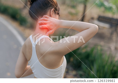 Sport activity in public park with southeast Asian female teen jogging running for health experiencing pain during exercise holding her neck in discomfort outdoors 126319981