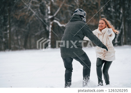 Lovely couple are together, enjoying walk and each other outdoors at winter season 126320295