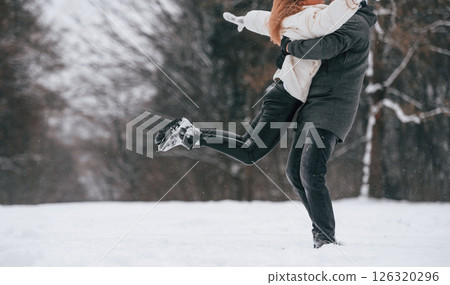Lovely couple are together, enjoying walk and each other outdoors at winter season 126320296