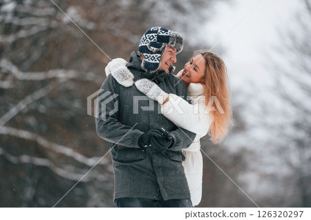 Lovely couple are together, enjoying walk and each other outdoors at winter season 126320297