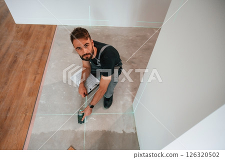 Top view. Man is installing new laminated wooden floor 126320502