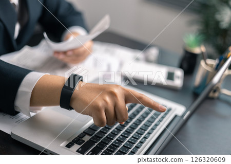 Finance bank tax expense accounting budget money businessman hand use calculator Financial calculate accountant close up calculator with graph chart write office desk Business expense analysis saving 126320609