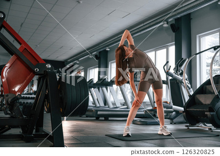 On the yoga mat. Beautiful woman with sport body type is in the gym 126320825