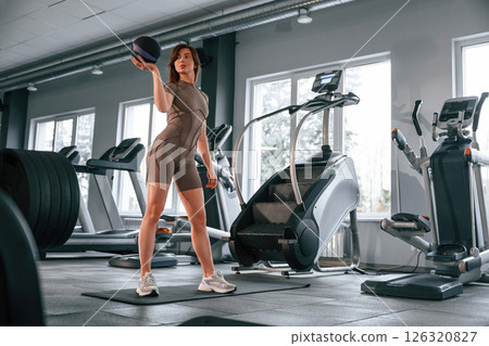On the yoga mat. Beautiful woman with sport body type is in the gym 126320827