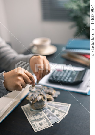 Finance bank tax expense accounting budget money businessman hand use calculator Financial calculate accountant close up calculator with graph chart write office desk Business expense analysis saving 126320984