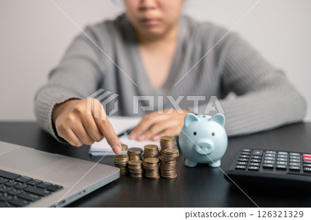 Finance bank tax expense accounting budget money businessman hand use calculator Financial calculate accountant close up calculator with graph chart write office desk Business expense analysis saving 126321329