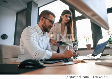 Side view. Paper work. Two employees are together in the modern office 126321389