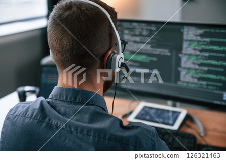 Software developer is writing code. Man in formal clothes is working in the modern office. Using computer 126321463
