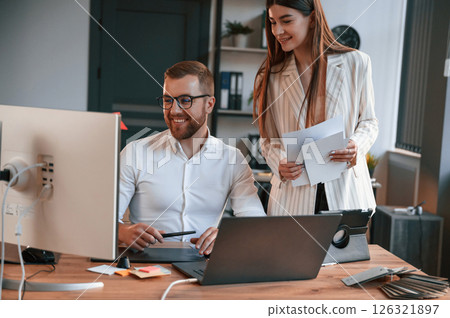 Designers are talking and working. Two employees are together in the modern office 126321897