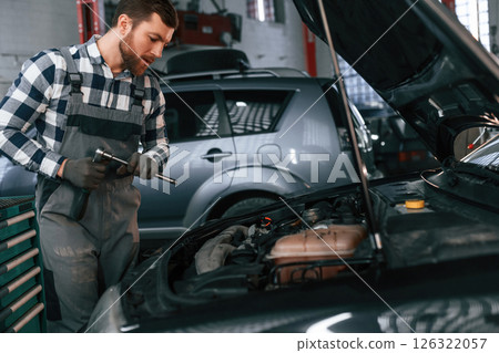 Man in uniform is working in the auto salon 126322057