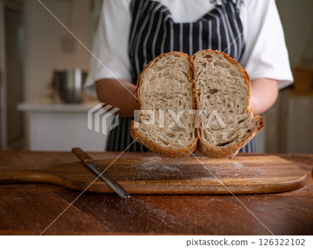 Artisan Sourdough Bread in Hand - Fresh from the Oven. 126322102