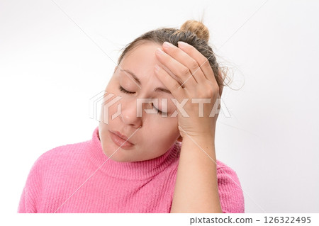 Woman with headache holding her head 126322495