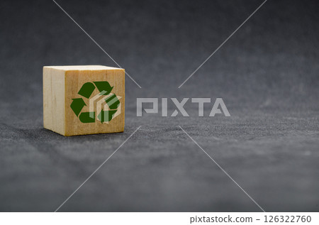 Recycle symbol on wooden cube on dark cover background. Reuse, reduce and recycle concept 126322760