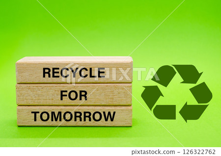 Recycle symbol with wooden blocks with text Recycle For Tomorrow on a green background. Promoting reuse, reduce, and recycle for sustainability Recycle symbol with wooden blocks with text Recycle For Tomorrow on a green background. Promoting reuse, reduce, and recycle for sustainability 126322762