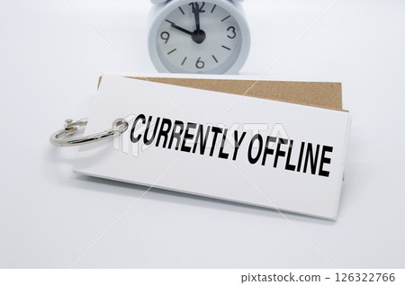 Currently Offline text on white notepad with alarm clock on white background. Away from office concept 126322766