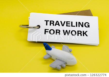 Traveling For Work text on white notepad with toy airplane on yellow cover background. Away from office concept Traveling For Work text on white notepad with toy airplane on yellow cover background. Away from office concept 126322774