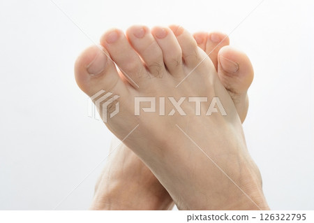 Close-up of human feet against a white background. 126322795