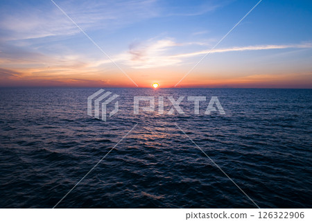 Aerial view sunset sky,Nature beautiful light sunset or sunrise over sea,Colorful dramatic majestic scenery sunset Sky with Amazing clouds and waves texture colorful sky cloud background 126322906