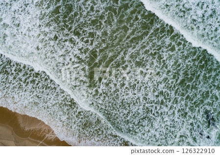 Aerial view Waves crashing on sandy shore,Sea surface in summer day background,Seascape top view waves texture background Aerial view Waves crashing on sandy shore,Sea surface in summer day background,Seascape top view waves texture background 126322910